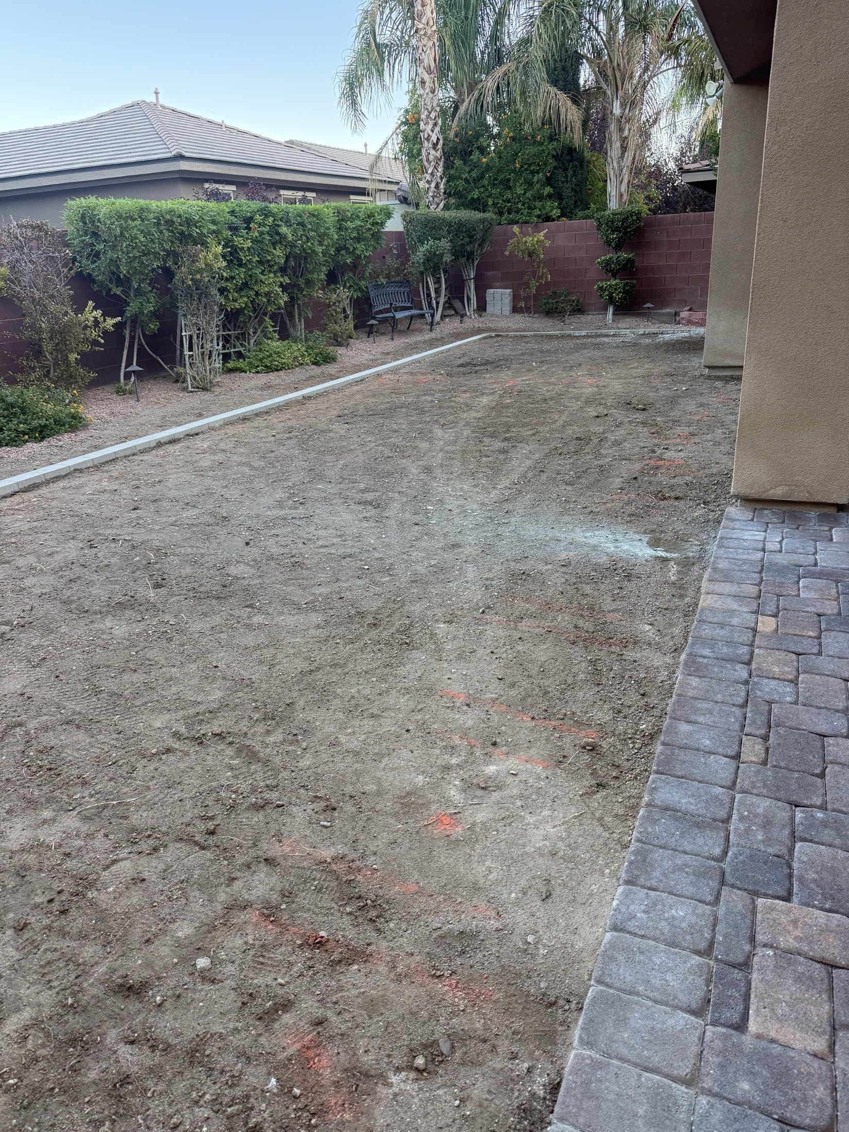 Bare dirt side yard before construction